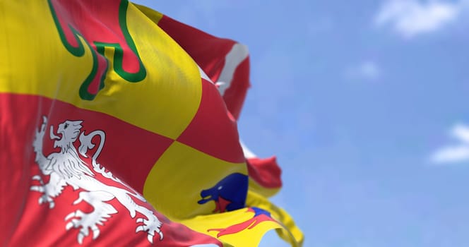 The flag of Auvergne-Rhone-Alps flying on a clear day. Auvergne-Rhone-Alpes is one of the regions of France.