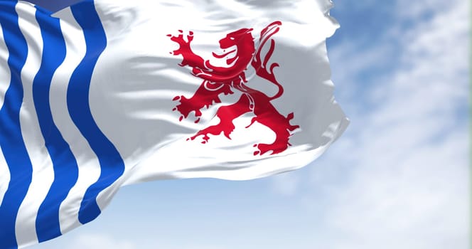 The flag of Nouvelle-Aquitaine waving in the wind on a clear day. Nouvelle-Aquitaine is the largest administrative region in France