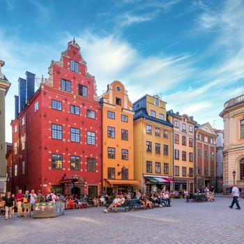 Stockholm, Sweden - June 26 2022: Stortorget, the big square, in Gamla Stan, old town, with traditional colorful old buildings on a summer day with tourists and locals walking and sitting at cafes