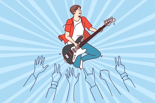 Crowd enjoying concert of male artist. Man performer playing guitar on stage for audience. Flat vector illustration.