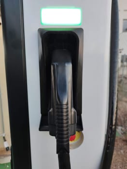 Vehicle connector at electric car charging station. Selective focus