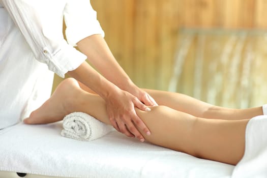 Close up portrait of a woman legs receiving a massage in spa