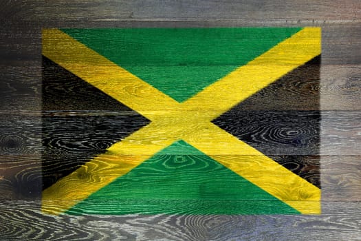 A Jamaica flag on rustic old wood surface background