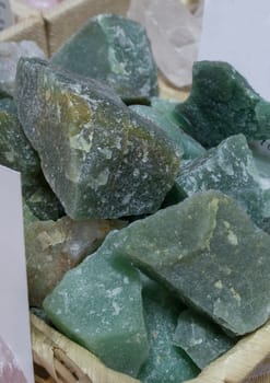 Green quartz fragments, believed to have beneficial health properties. Displayed on basket at street market stall