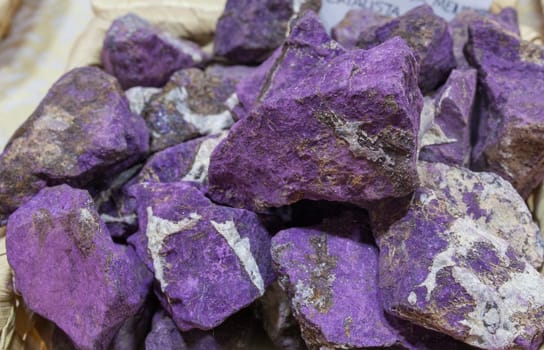 Fragments of purpurite believed to have beneficial health properties. Displayed on basket at street market stall