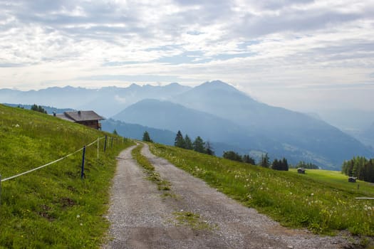 Landscape of Lienz Dolomites in Austria. Road and panorama of massive Alpine mountains. East Tyrol