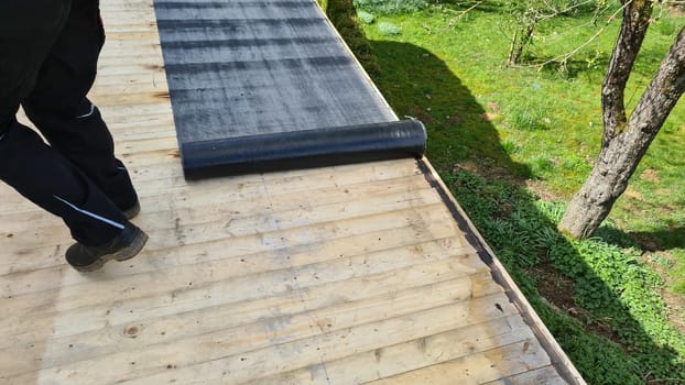 Roofing felt welding on bitumen roof roof repair with roofing felt and open flame propane tool on flat roof, leak with free space for text