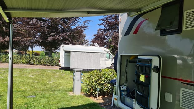Campers parked on a Camer Van pitch. Concept camper van leisure and fun