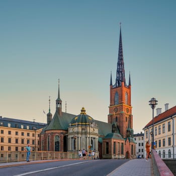 Stockholm, Sweden - June 25 2022: Riddarholmen Church, located in the island of Riddarholmshamnen, old city, Gamla stan. View from Riddarholmsbron bridge before sunset in a summer day