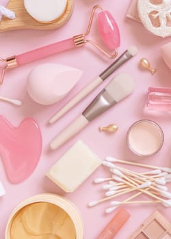 Skin care and makeup products on light pink, top view. Flat lay with natural beauty products and decorative cosmetics. Everyday woman face care routine. Pastel composition