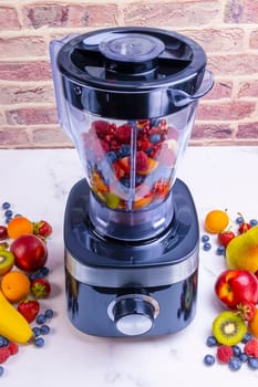 Fresh fruit smoothie in blender. Preparing a fresh drink full of vitamins for a healthy diet.