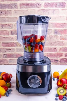 Fresh fruit smoothie in blender. Preparing a fresh drink full of vitamins for a healthy diet.