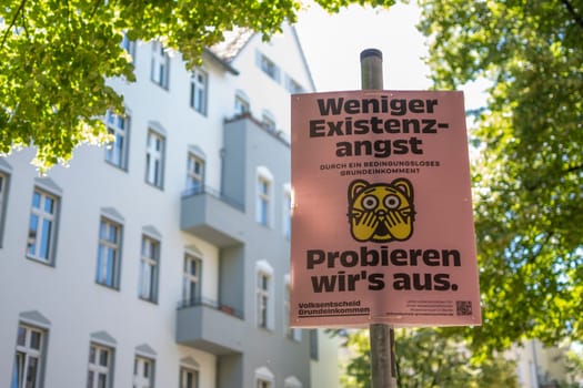 Berlin, Germany, June 2022: Volksentscheid direct democracy political advertisement in Berlin promoting UBI