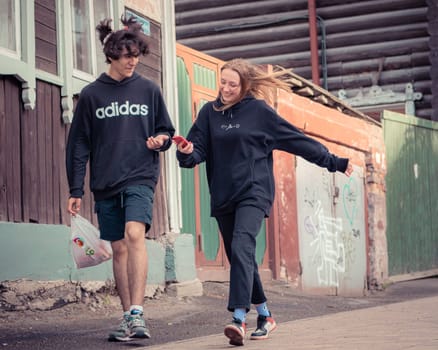 1st of June 2022, Russia, Tomsk, boy and girl walk on street editorial