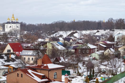Orthodox Church of St. Catherine in the Ukrainian city of Chernihiv and a view of the city in winter with snow. Old beautiful temple in the city