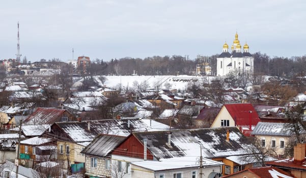 Orthodox Church of St. Catherine in the Ukrainian city of Chernihiv and a view of the city in winter with snow. Old beautiful temple in the city
