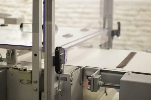 Line for the production of chocolate in an industrial factory. Automatic process in the production line of sweets. Images from the chocolate factory during production. Conveyor belt with sweets