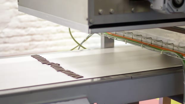 Factory for the production of sweets and chocolate. Automatic line for the production of chocolate in an industrial factory. Conveyor belt with sweets. Sweets production process. Food industry