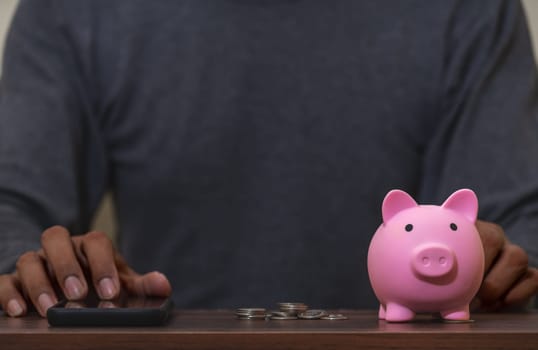 Save money and account banking for finance concept, Piggy bank with coin on blurred background, Save Monney for Investors Using Internet to Trade Stocks or Trade Fund