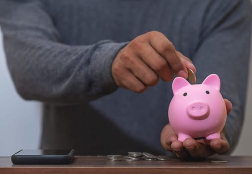 Save money and account banking for finance concept, Piggy bank with coin on blurred background, Save Monney for Investors Using Internet to Trade Stocks or Trade Fund