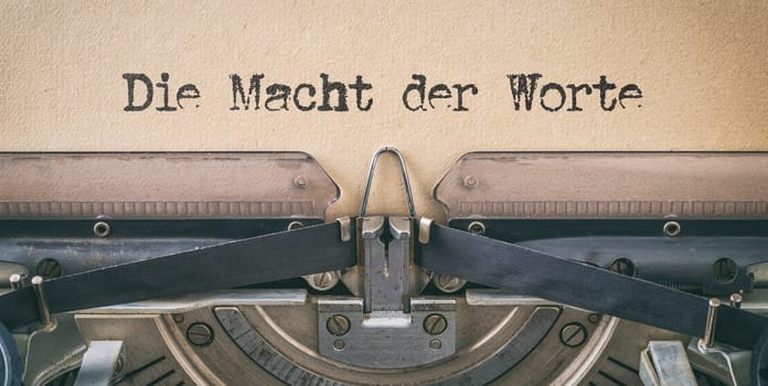 Text written with a vintage typewriter - The power of words in german - Die Macht der Worte