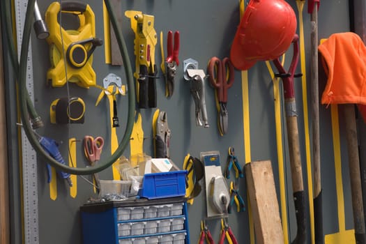 tools hanging on the wall workshop equipment helmet shovel scissors cutters for gardening hardware
