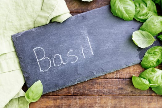 Fresh basil and a chalkboard sign with Basil written on it