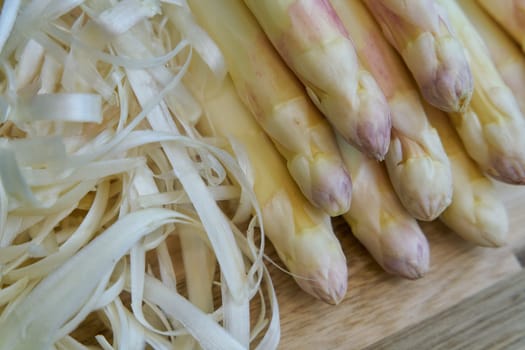 Peeled white asparagus, directly from the field on a kitchen table