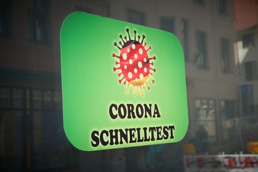 Sign on a shop window in Germany with the inscription Corona Schnelltest. Translation: Corona Quick Test