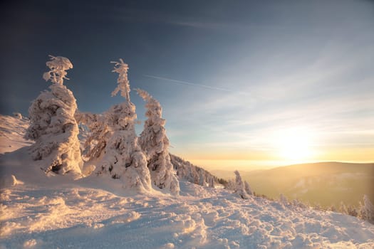 Winter scenery of the Sudetes Mountains on the Polish-Czech border during sunrise