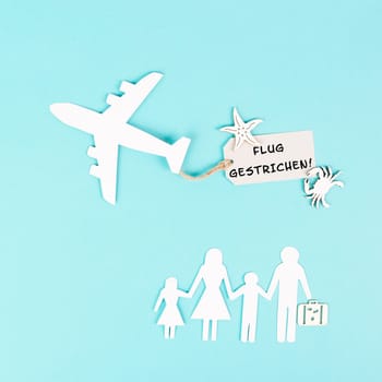 The words flight canceled are standing in german language on the sign of the airplane, staff shortage at the airport, vacation delayed for family
