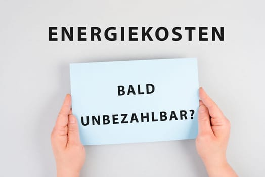 Energy prices soon unaffordable is standing in german language on the paper, increasing prices , high living expenses, gas and electricity costs, inflation
