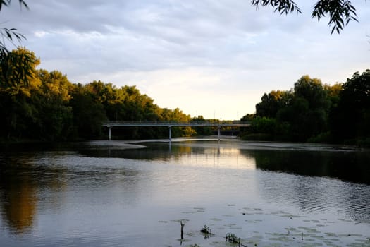 Panoramic View of Old blue Bridge across Still Waters of River.
