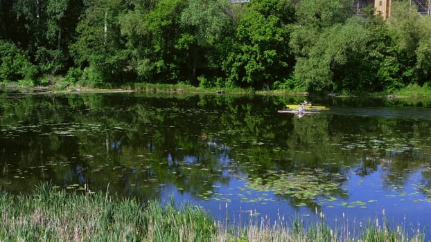 Group of happy people on a kayaks on the river in sunny day