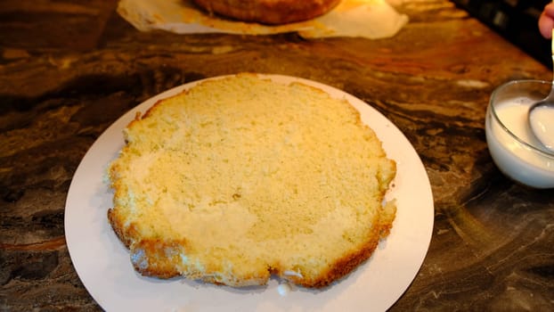 close-up of man making a cake. impregnation of sponge cake with milk. Cooking biscuit cake.