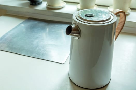 White electric kettle standing on the kitchen counter