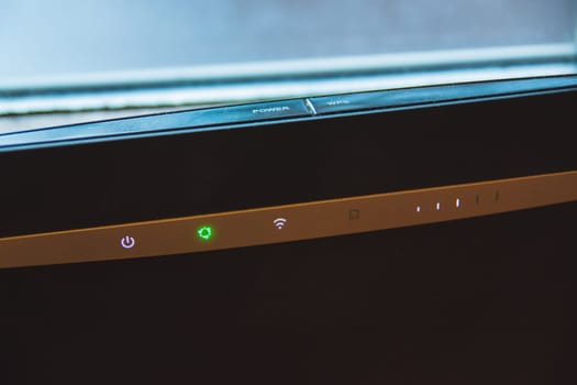 Home internet wifi router and backlit indicators, closeup