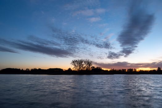 Small clouds after sunset on the lake, Stankow, Poland