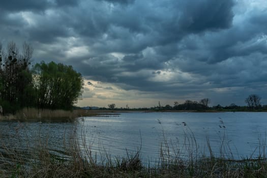 Dark storm clouds over the lake, spring view, Stankow, Poland