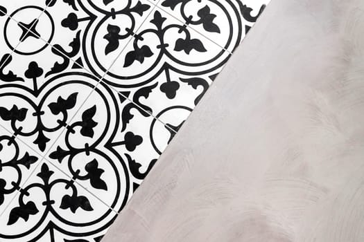 Decorated floor in resin and tiles. Black and white.