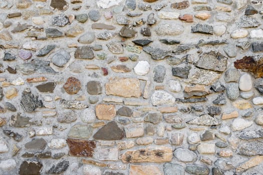 Rustic wall with uneven stones. It can be used as texture and background.