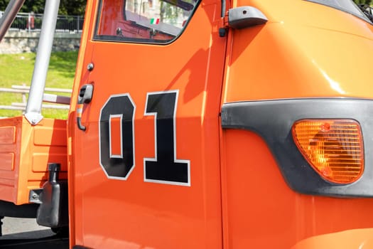 Piaggio ape disguised as The Dukes of Hazzard General Lee Orange. Bergamo, ITALY - May 17, 2022.