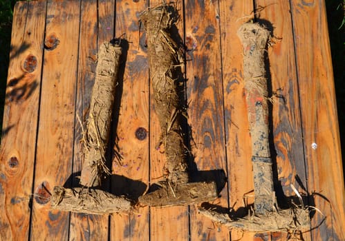 Dirty hammers of earth and straw used in construction with natural materials