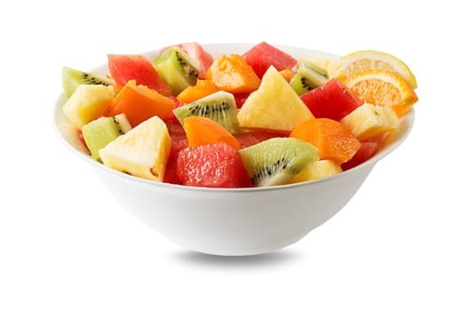 Bowl of healthy fresh tropical fruit salad on white background. Top view.