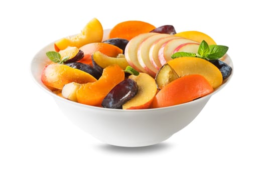 Bowl of healthy fresh fruit salad isolated on white background