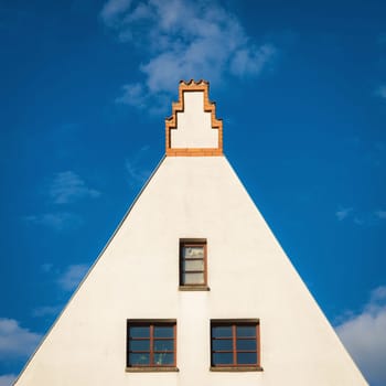 Red old gabled house facade with bay window in the old town of Wismar