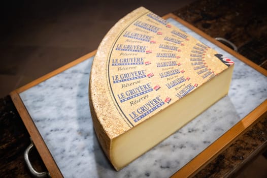 July 11 2022, Lyon, France : Switzerland cheese : Le Gruyère Réserve, famous swiss cheese in a cellar on a marbble background