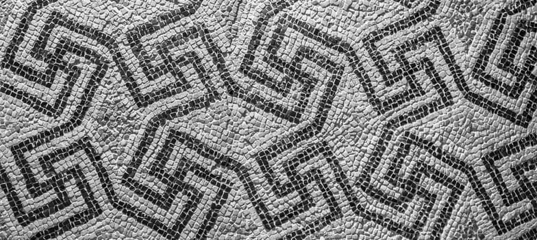 Swastika symbol in ancient Celtic mosaic decoration. Design for an old style background.