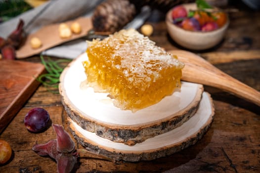 Piece of fresh honey cut with a knife on a traditional table
