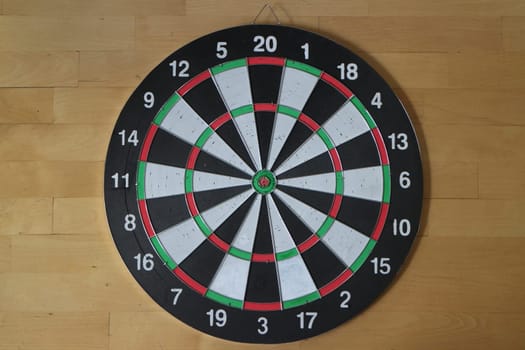 Target for playing darts wooden background